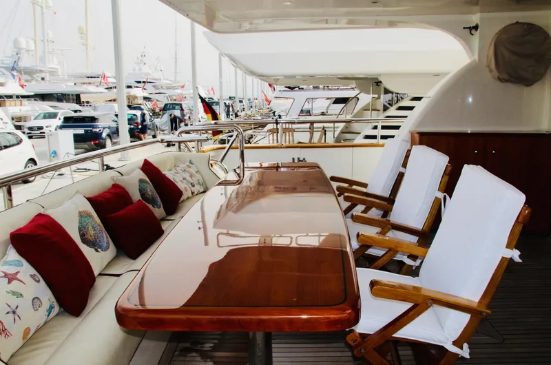  Yacht Photos Pics Luxurious Monte Fino 82 yacht deck with elegant dining area, 2005 model.