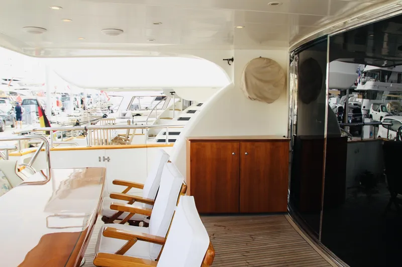  Yacht Photos Pics Luxurious 2005 Monte Fino 82 yacht deck with seating and wooden cabinetry.