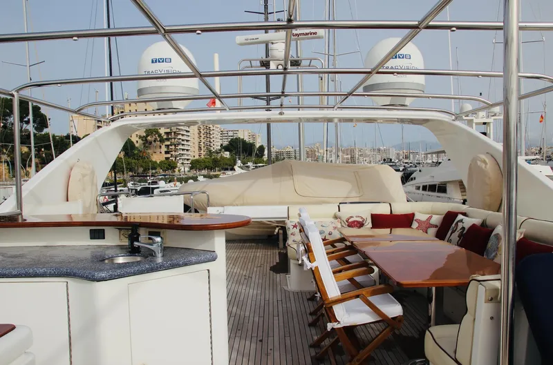 Yacht Photos Pics Luxurious 2005 Monte Fino 82 yacht deck with seating and dining area.
