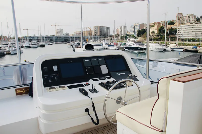  Yacht Photos Pics Control deck of a 2005 Monte Fino 82 yacht in a marina setting.