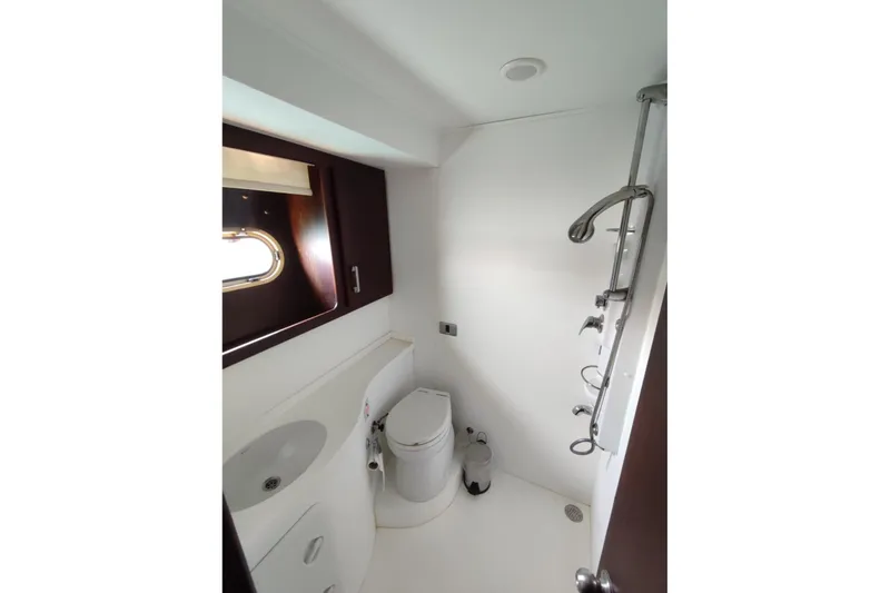  Yacht Photos Pics Bathroom interior of 2007 Custom 85 Motor Yacht with modern fixtures and porthole window.