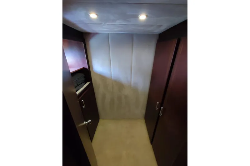  Yacht Photos Pics Interior hallway of 2007 Custom 85 Motor Yacht with wooden cabinets and soft lighting.