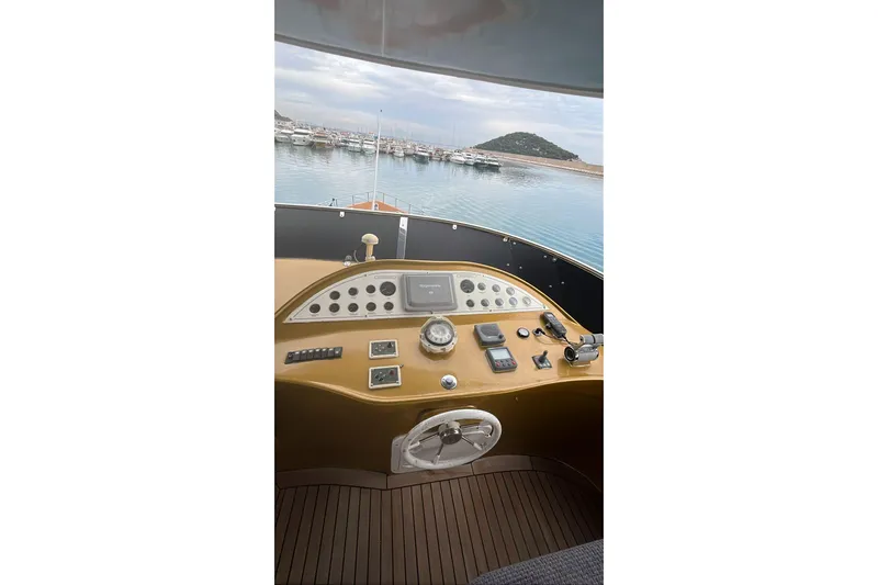  Yacht Photos Pics Control panel of a 2007 Custom 85 Motor Yacht overlooking a serene marina.