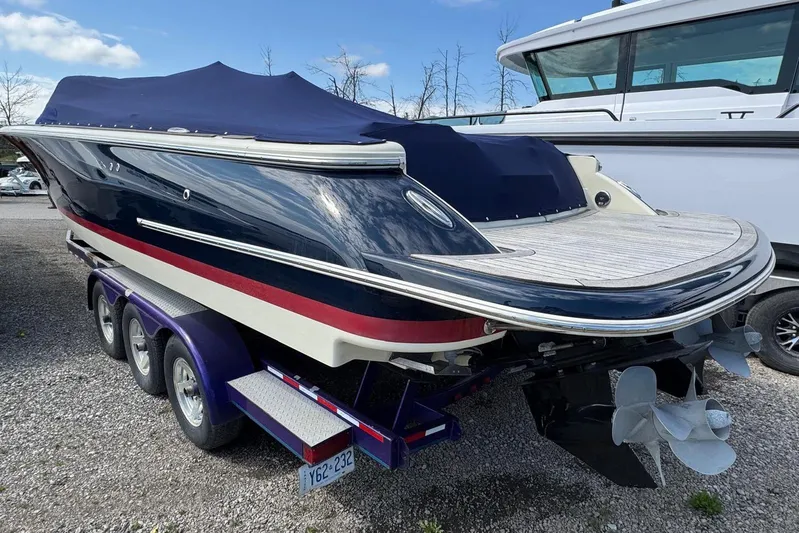 Yacht Photos Pics 2013 Chris-Craft Launch 28 boat on trailer, covered, parked outdoors.