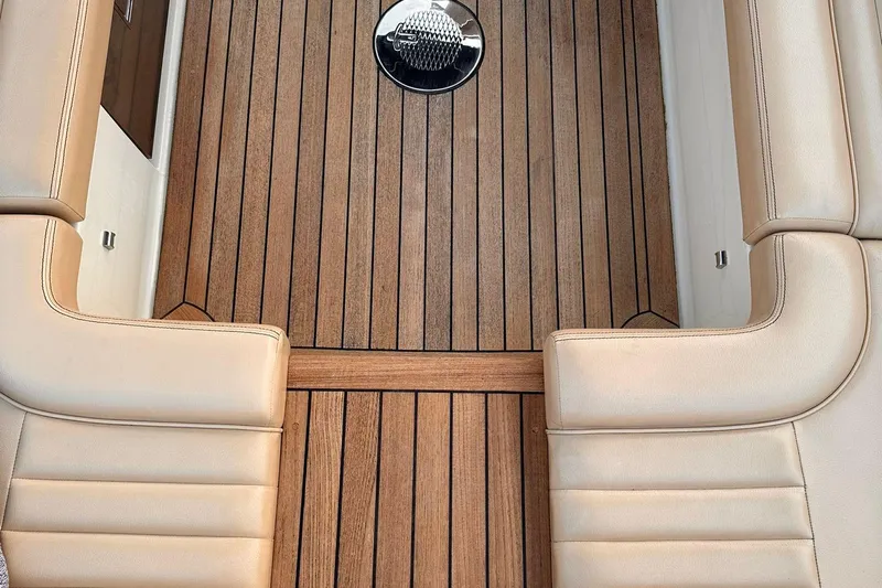  Yacht Photos Pics 2013 Chris-Craft Launch 28 interior with teak flooring and beige leather seating.