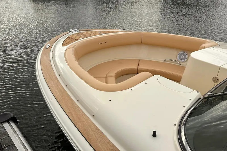  Yacht Photos Pics 2013 Chris-Craft Launch 28 boat with tan seating and wooden deck, docked on calm water.