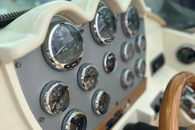  Yacht Photos Pics Dashboard of 2013 Chris-Craft Launch 28 boat with gauges and wooden steering wheel.