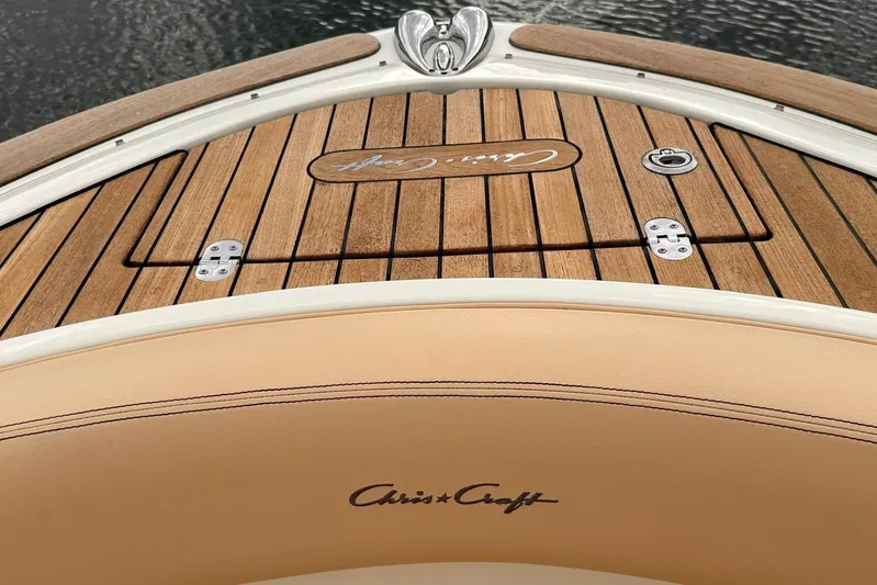  Yacht Photos Pics 2013 Chris-Craft Launch 28 boat with teak deck and logo, docked on water.