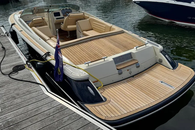  Yacht Photos Pics 2013 Chris-Craft Launch 28 boat docked, featuring elegant teak decking and luxurious seating.
