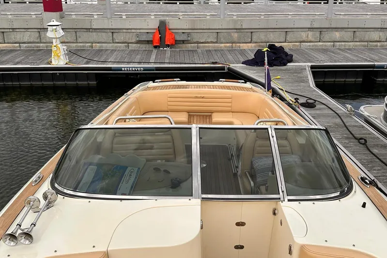  Yacht Photos Pics 2013 Chris-Craft Launch 28 boat docked, featuring tan leather seating and sleek design.