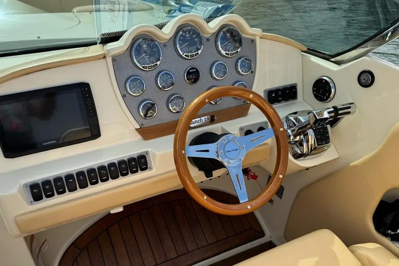  Yacht Photos Pics 2013 Chris-Craft Launch 28 dashboard with wooden steering wheel and modern controls.
