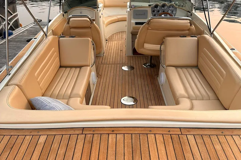  Yacht Photos Pics 2013 Chris-Craft Launch 28 boat interior with tan leather seating and wooden deck.