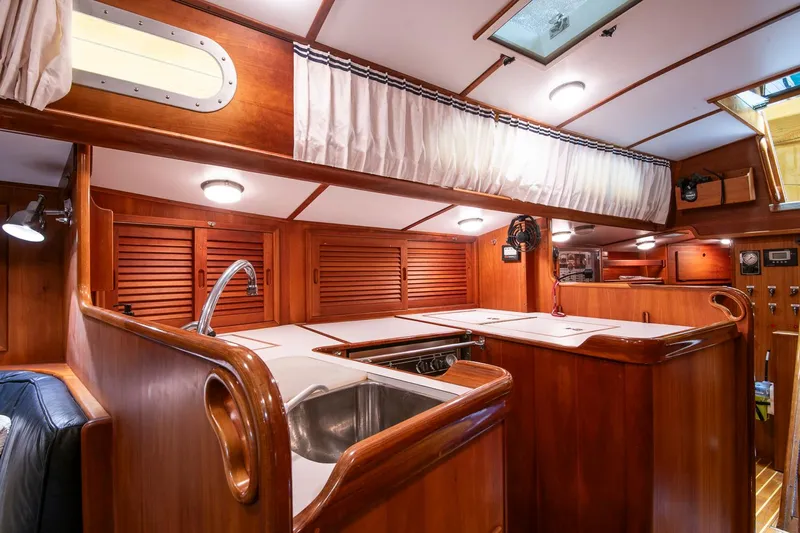 Regulus Yacht Photos Pics Interior of 1993 Hinckley Sou'wester 51 yacht with wooden cabinetry and modern amenities.