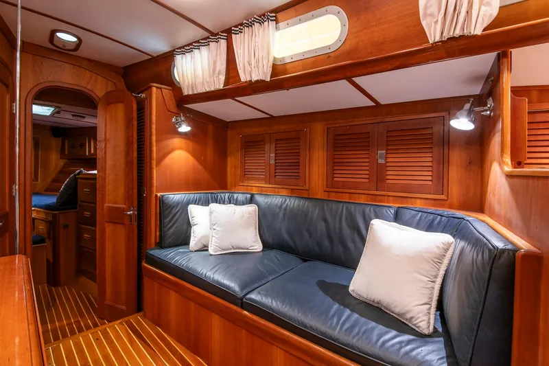 Regulus Yacht Photos Pics Luxurious 1993 Hinckley Sou'wester 51 yacht interior with wooden paneling and leather seating.