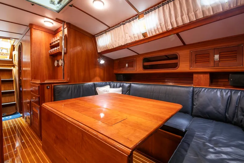 Regulus Yacht Photos Pics Luxurious wooden interior of 1993 Hinckley Sou'wester 51 yacht with cozy seating area.