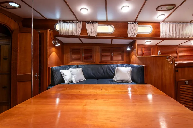 Regulus Yacht Photos Pics Luxurious interior of 1993 Hinckley Sou'wester 51 yacht with wooden finishes and cozy seating.