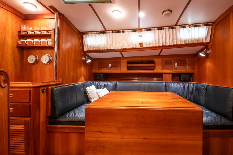 Regulus Yacht Photos Pics Luxurious wooden interior of 1993 Hinckley Sou'wester 51 yacht with cozy seating area.