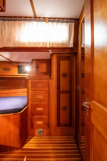 Regulus Yacht Photos Pics Interior of 1993 Hinckley Sou'wester 51 yacht with wooden cabinetry and cozy sleeping area.