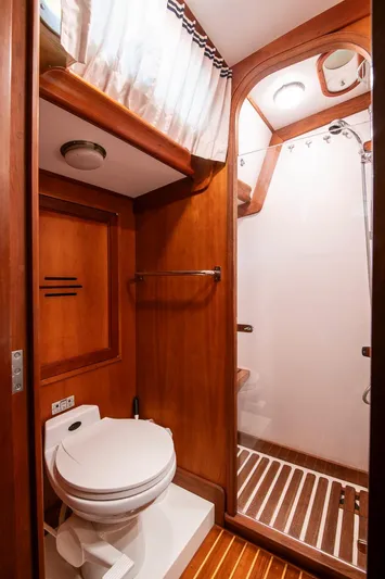 Regulus Yacht Photos Pics Hinckley Sou'wester 51 yacht bathroom, 1993 model, featuring wooden interior and shower.