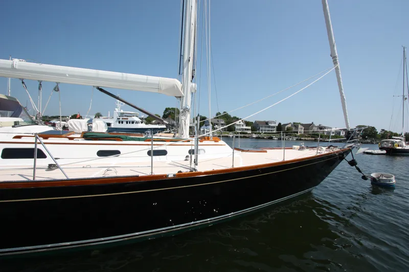 Regulus Yacht Photos Pics Hinckley Sou'wester 51 sailboat, 1993 model, docked in a sunny marina.