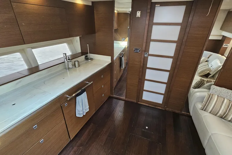 My Way Yacht Photos Pics Luxurious interior of 2013 Sea Ray 470 Sundancer yacht with modern kitchen and seating area.