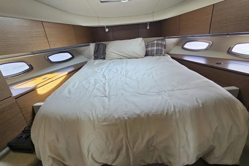 My Way Yacht Photos Pics Luxurious cabin interior of 2013 Sea Ray 470 Sundancer with cozy bed and elegant wood paneling.