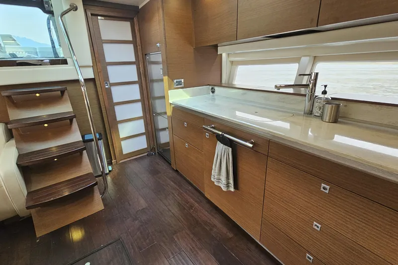 My Way Yacht Photos Pics Luxurious kitchen interior of 2013 Sea Ray 470 Sundancer yacht with wooden cabinetry.