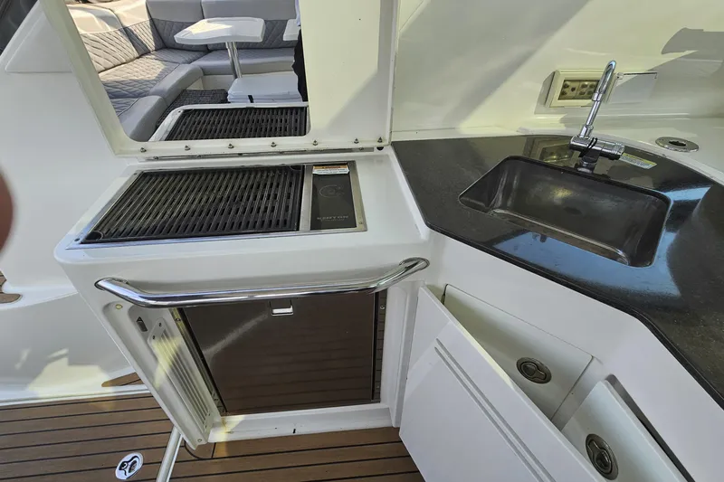 My Way Yacht Photos Pics Outdoor kitchen on 2013 Sea Ray 470 Sundancer yacht with grill, sink, and seating area.