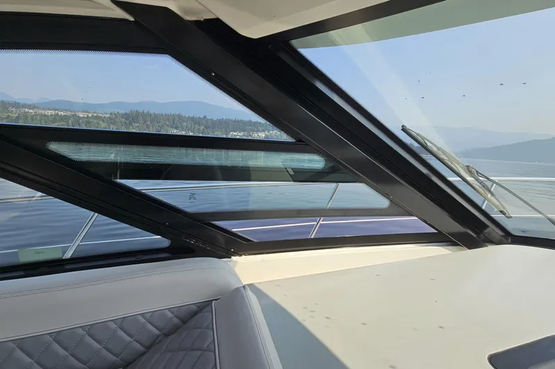 My Way Yacht Photos Pics Interior view of 2013 Sea Ray 470 Sundancer yacht with scenic water and mountain backdrop.