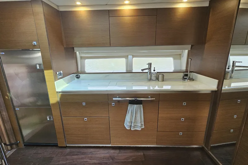 My Way Yacht Photos Pics Modern kitchen interior of 2013 Sea Ray 470 Sundancer yacht with wood cabinetry and stainless steel appliances.