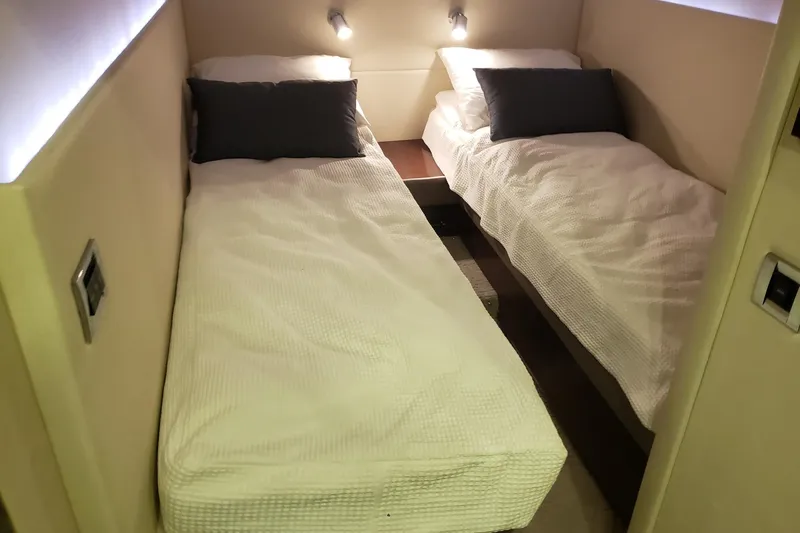 My Way Yacht Photos Pics Twin beds in the 2013 Sea Ray 470 Sundancer cabin, featuring modern lighting and cozy bedding.