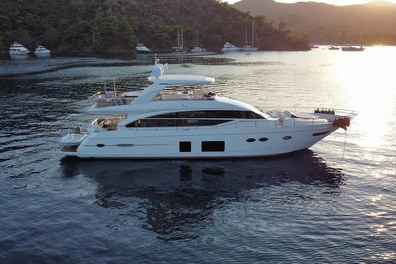 On Yacht Photos Pics Luxurious 2014 Princess 82 yacht anchored in scenic bay at sunset.