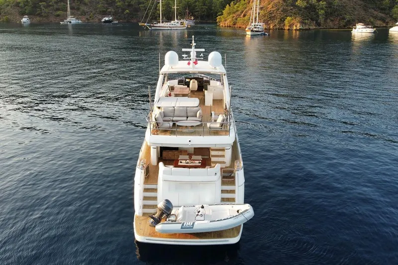 On Yacht Photos Pics Luxury Princess 82 yacht from 2014 anchored in serene waters with scenic backdrop.