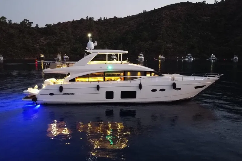 On Yacht Photos Pics Luxurious 2014 Princess 82 yacht illuminated at night on calm waters.