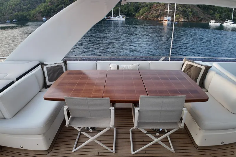 On Yacht Photos Pics Luxurious 2014 Princess 82 yacht deck with elegant dining area and scenic water view.