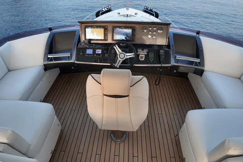 On Yacht Photos Pics Luxurious 2014 Princess 82 yacht helm with modern controls and plush seating.
