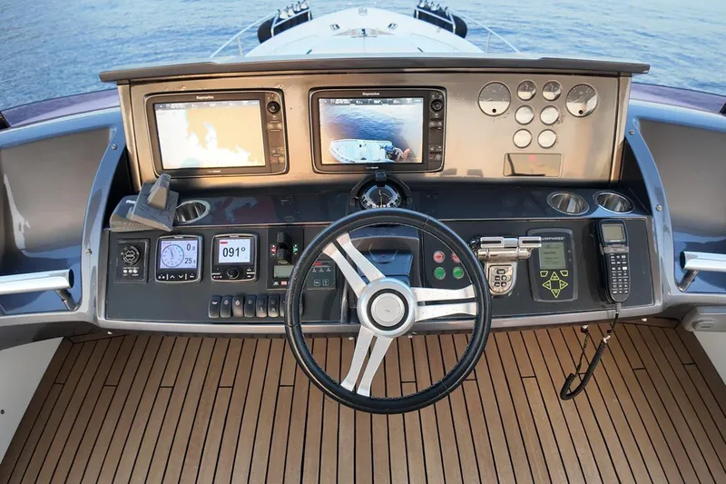 On Yacht Photos Pics Cockpit of 2014 Princess 82 yacht with navigation equipment and steering wheel.
