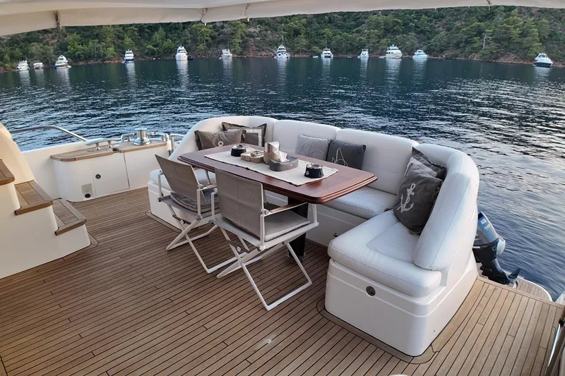 On Yacht Photos Pics Luxurious 2014 Princess 82 yacht deck with elegant seating and scenic waterfront view.
