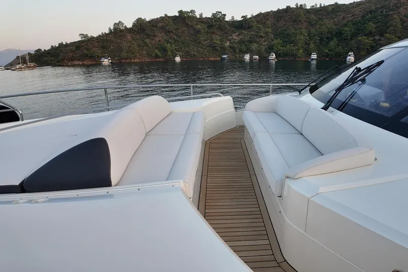 On Yacht Photos Pics Luxurious 2014 Princess 82 yacht with elegant seating, docked near scenic coastline.