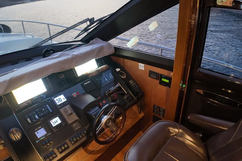 On Yacht Photos Pics Cockpit of 2014 Princess 82 yacht with navigation controls and leather seating.