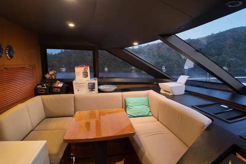 On Yacht Photos Pics Luxurious interior of 2014 Princess 82 yacht with scenic window view and cozy seating area.