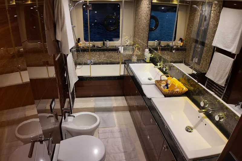 On Yacht Photos Pics Luxurious bathroom interior on a 2014 Princess 82 yacht, featuring dual sinks and elegant decor.