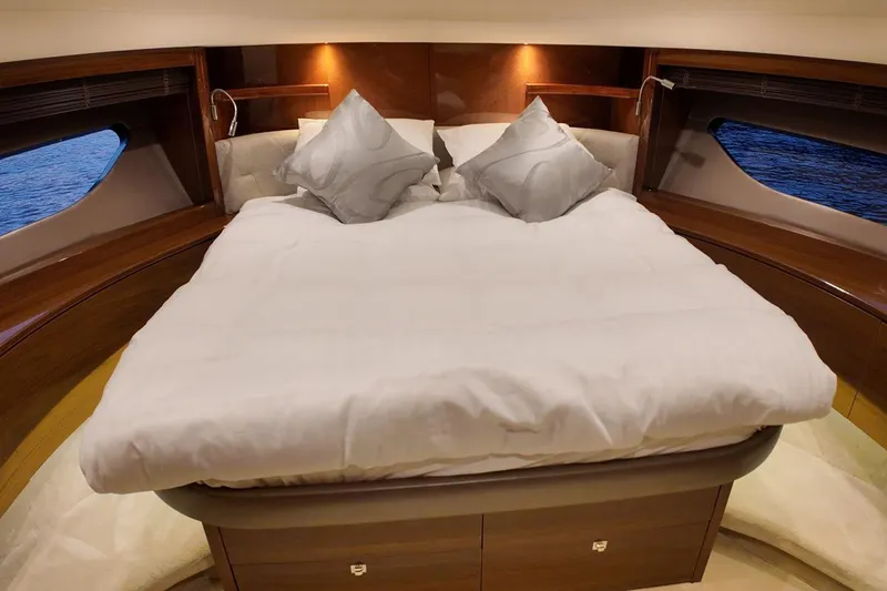 On Yacht Photos Pics Luxurious bedroom interior of 2014 Princess 82 yacht with elegant bedding and ambient lighting.