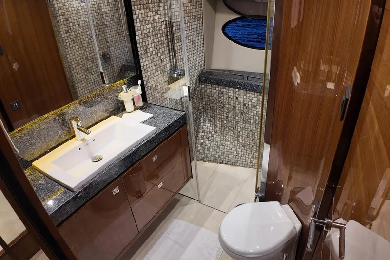 On Yacht Photos Pics Luxurious yacht bathroom with modern fixtures, mosaic tiles, and wood accents, Princess 82, 2014 model.