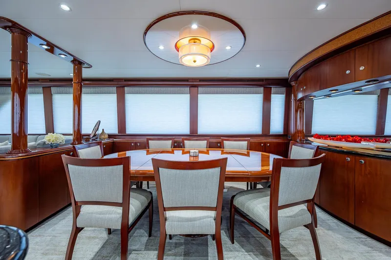 Lady Lorraine Yacht Photos Pics Luxurious dining area in a 2007 Cheoy Lee Bravo Flybridge Motor Yacht with elegant wood finishes.
