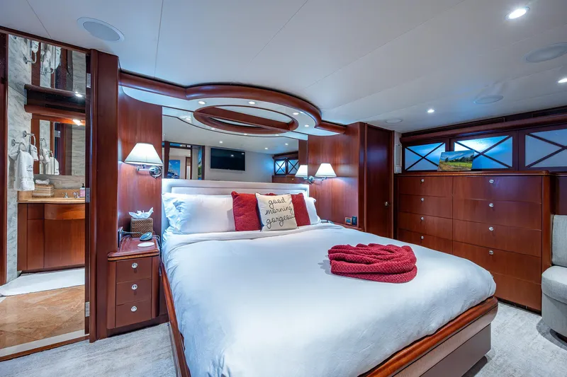 Lady Lorraine Yacht Photos Pics Luxurious bedroom in 2007 Cheoy Lee Bravo Flybridge Motor Yacht with elegant wood finishes.