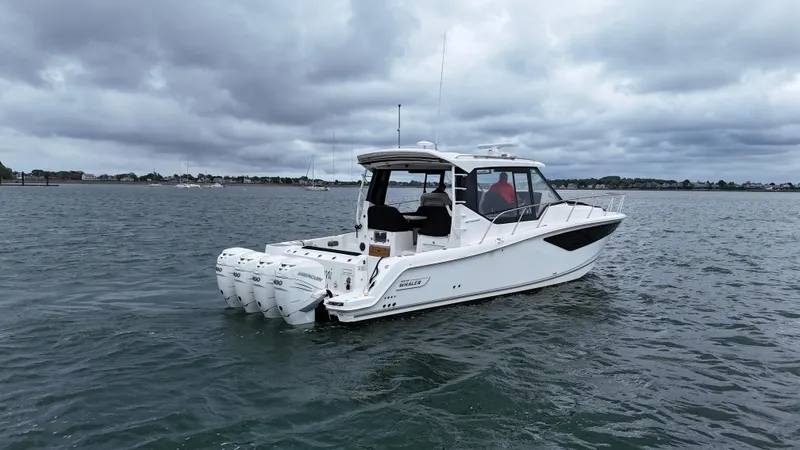  Yacht Photos Pics 2021 Boston Whaler 405 Conquest boat on water under cloudy sky.