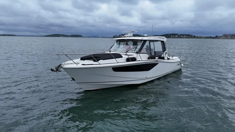  Yacht Photos Pics 2021 Boston Whaler 405 Conquest boat on calm water under cloudy skies.