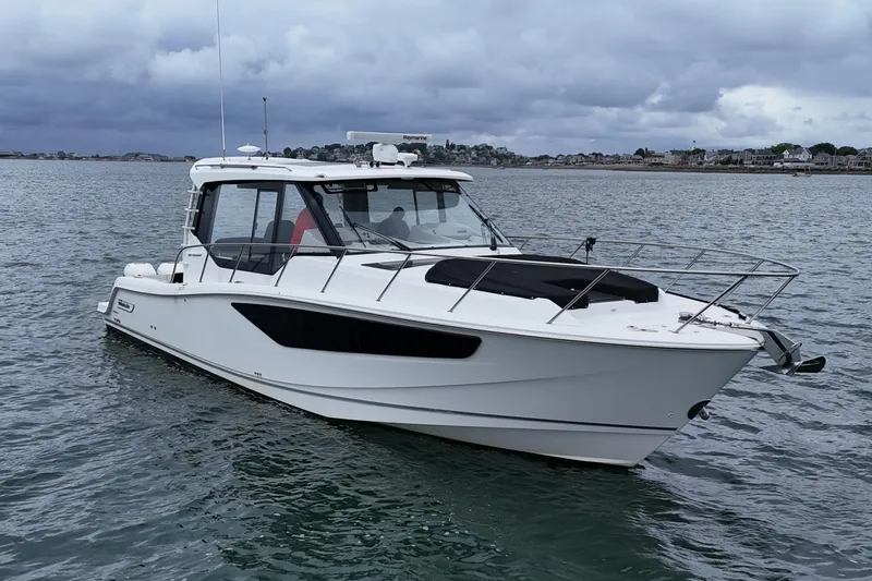  Yacht Photos Pics 2021 Boston Whaler 405 Conquest boat on calm water under cloudy skies.