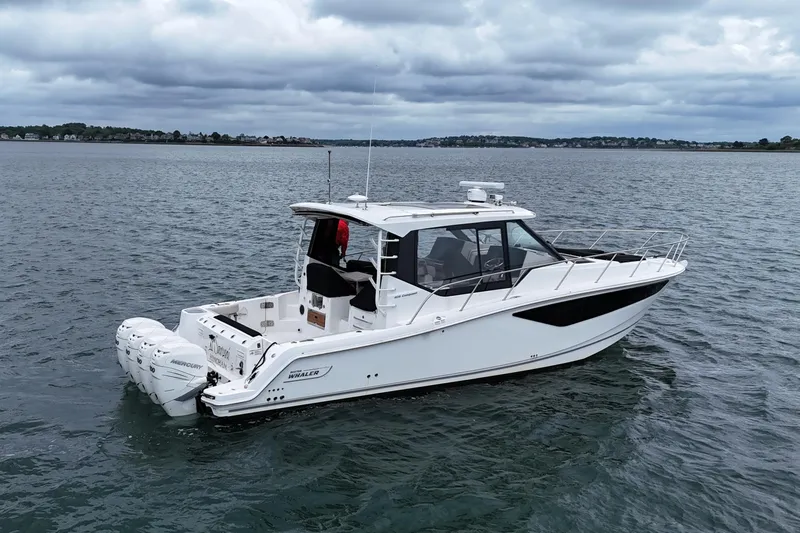  Yacht Photos Pics 2021 Boston Whaler 405 Conquest boat on calm water under cloudy skies.